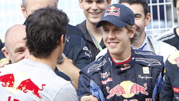 Mark Webber shakes hands with victorious Sebastian Vettel after the Valencia Grand Prix.