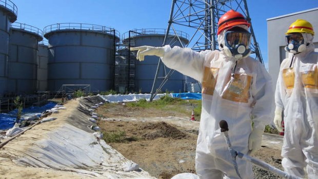 Japanese Economy, Trade and Industry Minister Toshimitsu Motegi (red helmet) inspecting contamination water tanks at TEPCO's Fukushima Dai-ichi nuclear power plant in Fukushima prefecture.