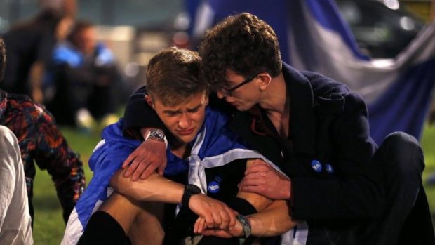 Distraught "Yes" supporters comfort each other in George Square, Glasgow.
