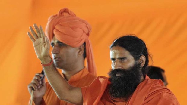 Spiritual guru Baba Ramdev (right) gestures to supporters before a hunger strike that began yesterday in Delhi.