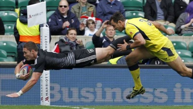 Overwhelmed: Gillies Kaka scores for the All Blacks as Australia blows a 21-point lead.