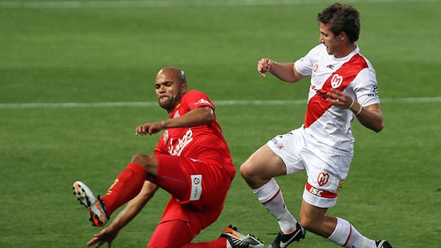 Missed again: Heart's Michael Marrone is beaten to the ball by Adelaide United's Serginho van Dijk.