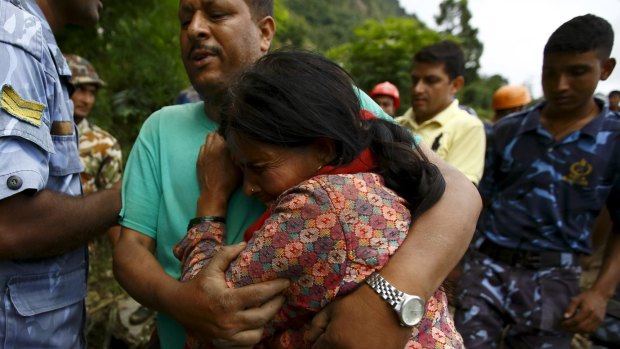 A family member cries after a dead body is recovered from the landslide at Lumle village in Kaski district, close to the nation's most popular trekking circuit.