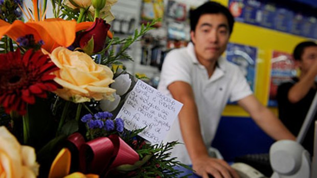 A floral tribute inside the newsagent where Stacy  worked with manager Robert Liu.