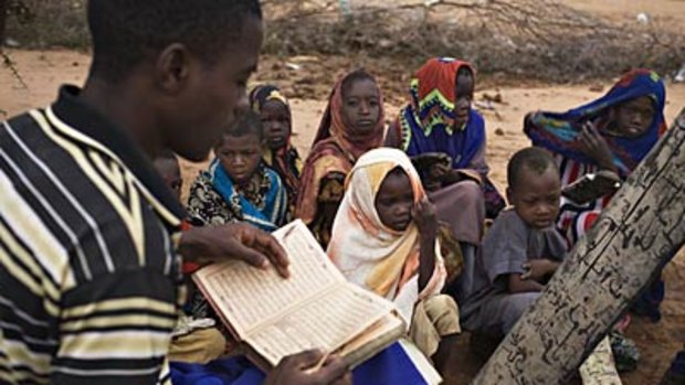 On the border... Somali children attend a makeshift classroom at a refugee camp just inside Kenya.