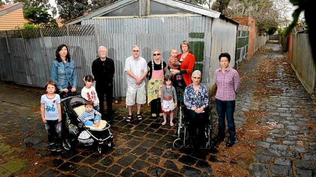 Residents opposed to concreting laneways gather in one of Brunswick's bluestone lanes.