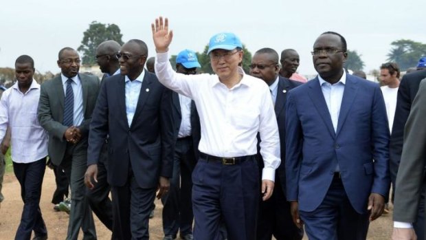 Keeping watch: UN Secretary-General Ban Ki-Moon waves as he visits the Bangui IDP camp.