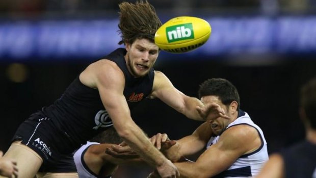Hair-raising: Bryce Gibbs is airborne in his pursuit of the ball against Geelong. 