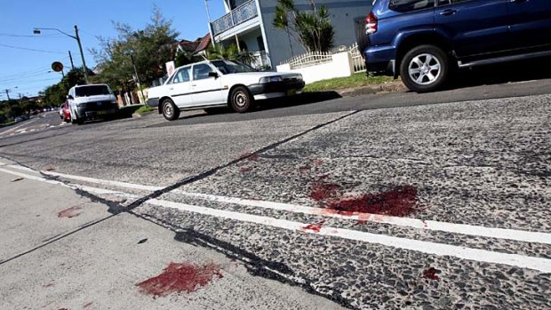 Bloodstains on the road outside the Marrickville house after the fatal stabbing.