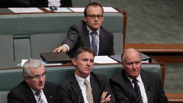 Independent MPs Andrew Wilkie, Rob Oakeshott and Tony Windsor listen as MPs debate the bill. Photo: Alex Ellinghausen