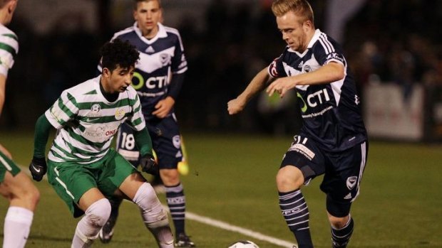 Connor Pain of Melbourne Victory takes on Muad Zwed of Tuggeranong United.