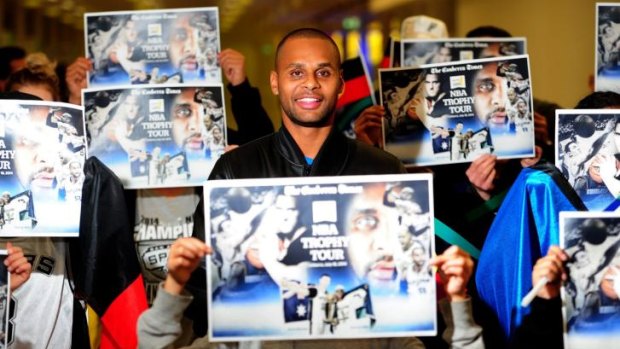 Patty Mills with the limited edition <i>The Canberra Times</i> posters, which will be available at Friday's Civic reception.