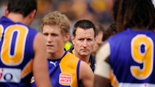 Eagle eyes: West Coast coach John Worsfold joins his players in their quarter-time huddle yesterday.