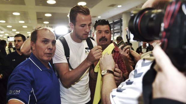 Welcome attention: Tottenham striker Harry Kane is greeted by fans at Sydney airport.