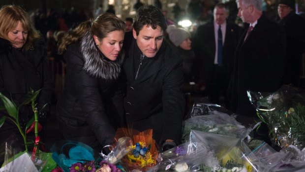 Canadian Prime Minister Justin Trudeau and his wife Sophie Gregoire Trudeau place flowers at a makeshift memorial on Monday.
