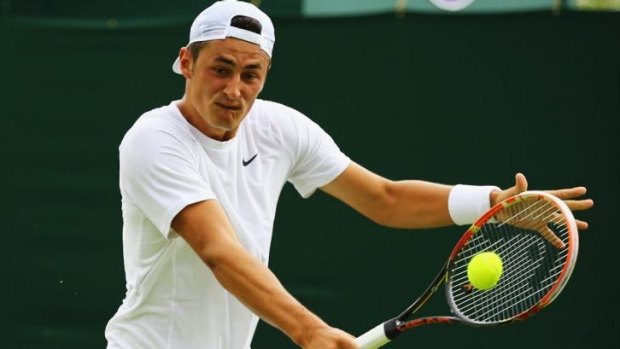 Bernard Tomic plays a backhand during his first-round match against Evgeny Donskoy.