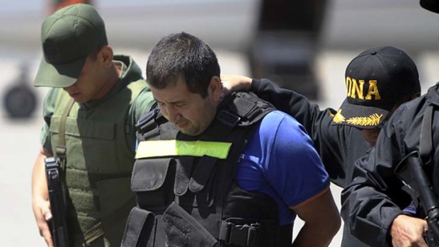 Members of the Venezuelan national guard escort Daniel 'El Loco' Barrera, one of Colombia's most wanted drug traffickers