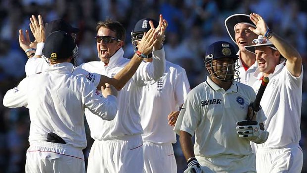 Graeme Swann (second from left) and his England teammates celebrate the wicket of India's Sachin Tendulkar at The Oval.