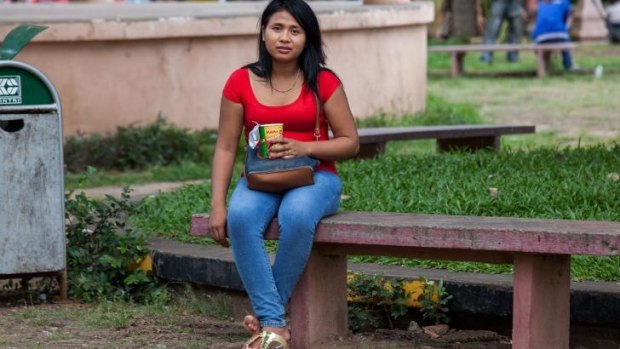A sex worker sits on one of the benches of Wat Phnom Park, situated in central Phnom Penh. 