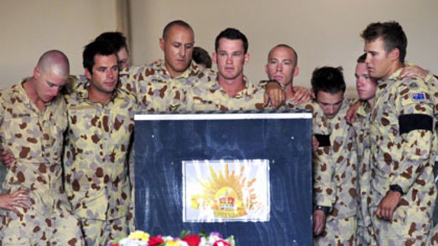 Soldiers from the 1st Mentoring Task Force farewell the body of Private Nathan Bewes, who was killed by an improvised explosive device.