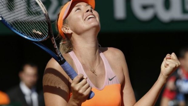 The queen of clay: Sharapova celebrates her victory over Bouchard.