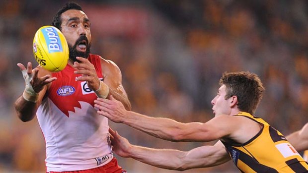 Adam Goodes tries to escape the grasp of Hawthorn's Liam Shiels at the MCG.