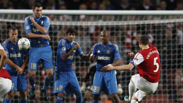 Arsenal's Thomas Vermaelen attempts to clear the Marseille wall with a free-kick.