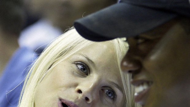Working to save his family ... in this June 11, 2009, file photo, Elin Nordegren talks to her husband, Tiger Woods during an NBA game.
