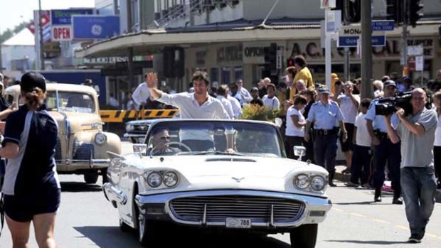 Home-town hero Mark Webber parades along the main street of Queanbeyan... without any mechanical problems.