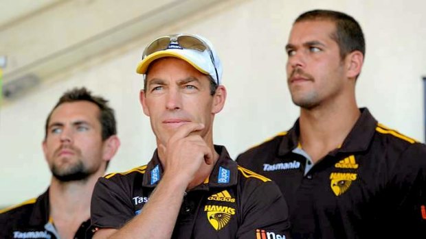 Plenty to think about: coach Alastair Clarkson flanked by Luke Hodge and Lance Franklin at Hawthorn's family day in March.