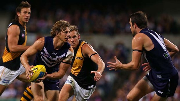 Fremantle's Nathan Fyfe looks to move the ball on against Richmond.
