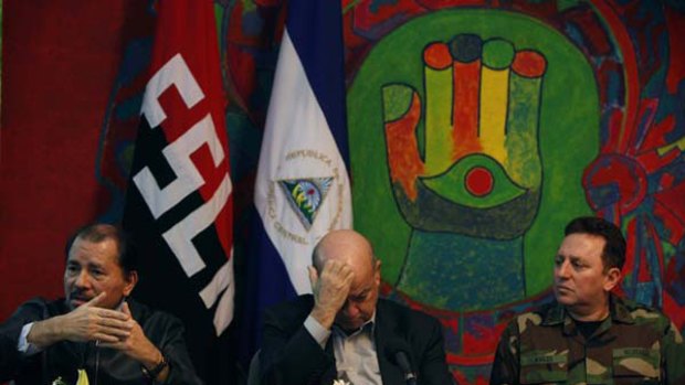 Nicaragua's President Daniel Ortega, left, speaks during a press conference next to the Secretary General of the Organization of American States, Jose Miguel Insulza, center, and Nicaragua's Chief of the Army Cesar Aviles on Saturday.