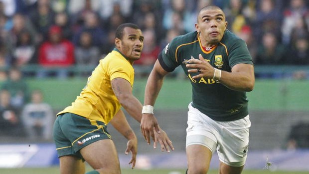 Outpaced: South African player Bryan Habana, right, runs for the ball against Will Genia, in Cape Town, last Saturday.