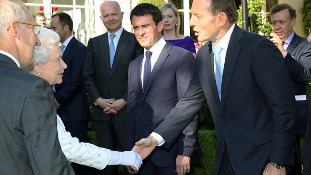 Mr Abbott greets Queen Elizabeth II at the event in France.