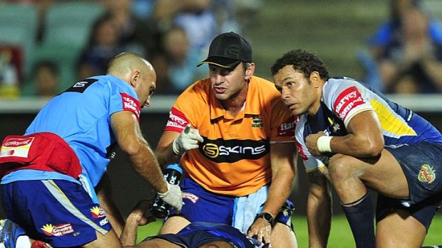 Callous blow ... Johnathan Thurston of the Cowboys receives treatment after being elbowed by Matt Prior.