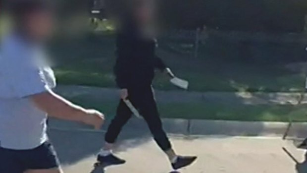 A teen is seen with a kitchen knife and a cleaver.