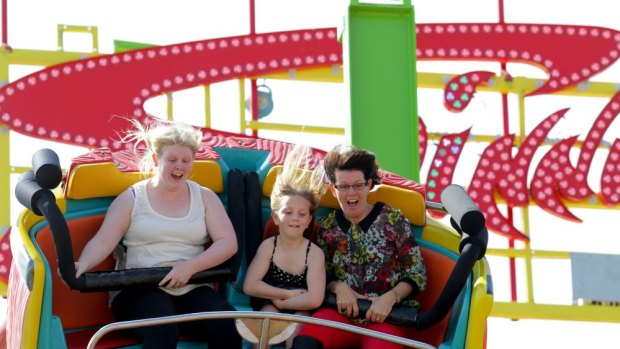 BRISBANE. NEWS. SUN-HERALD. BRISBANE TIMES. 
Photograph taken by Michelle Smith on Saturday 17th August, 2013. 
Niki Curley, 17, and Elizya Curley, 8, with their auntie Robyn Mafrici, are on the Spinning Coaster at the 2013 EKKA at the RNA Showgrounds, Brisbane. BRISBANE. NEWS. SUN-HERALD. BRISBANE TIMES.