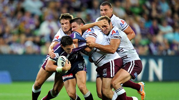 Storm’s Billy Slater holding off a pack of Sea Eagles earlier this year.