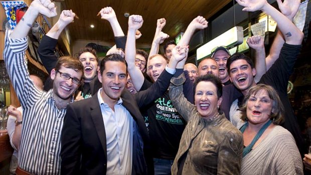 Celebration ... Alex Greenwich is congratulated by Clover Moore and other supporters after winning the Sydney byelection.