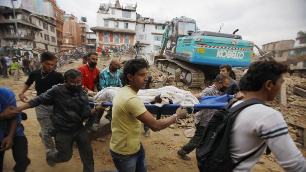 Volunteers carry the body of a victim on a stretcher, recovered from the debris of a building that collapsed after an earthquake  in Kathmandu, Nepal.