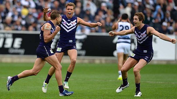 Oh yeah: Stephen Hill (left) celebrates with teammates the goal that delivered the Dockers victory at Simonds Stadium.