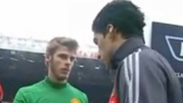 Patrice Evra, unseen, grabs Lus Suarez's right arm after the Liverpool striker refused to shake the Frenchman's hand.