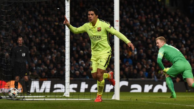 Double: Luis Suarez celebrates his second goal for Barcelona as City keeper Joe Hart looks on.