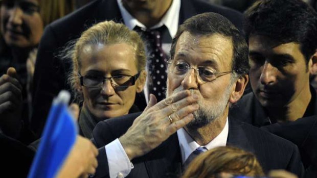 Spanish Popular Party (PP) leader Mariano Rajoy, pictured blowing a kiss during campaigning last week, is set to become the country's next Prime Minister.