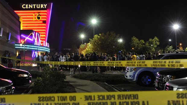 Tragedy ... People gather outside the Century 16 movie theatre in Aurora, Colorado.