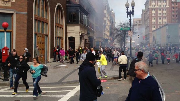 The scene of the Boston Marathon bombings, with one of the suspects (in the white hat) visible on the left.