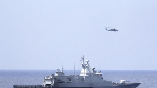 The Royal Malaysian Navy corvette KD Terengganu and a US Navy MH-60R Sea Hawk helicopter from the US Navy guided-missile destroyer USS Pinckney conduct a co-ordinated air and sea search for the missing Malaysia Airlines jet in the Gulf of Thailand. 