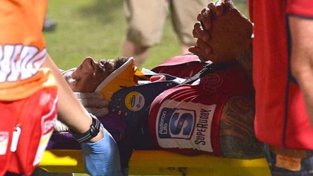 Quade Cooper is carried out on a stretcher in a neck brace during the Super Rugby trial match between the Queensland Reds and the Melbourne Rebels on Friday.