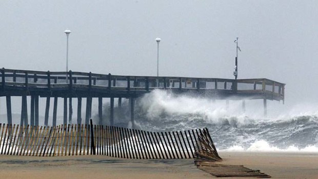 Bracing for trouble &#8230; waves crash into the pier in Ocean City, Maryland.