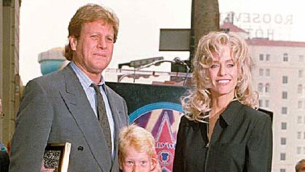 Family time ... Ryan O'Neal and Farrah Fawcett with their son Redmond in 1995.